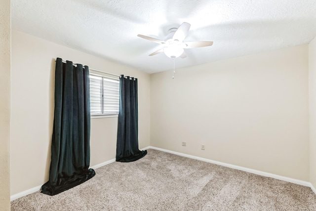 unfurnished room with ceiling fan, light colored carpet, and a textured ceiling