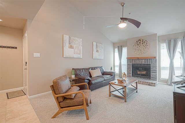 carpeted living room with a brick fireplace, vaulted ceiling, and ceiling fan