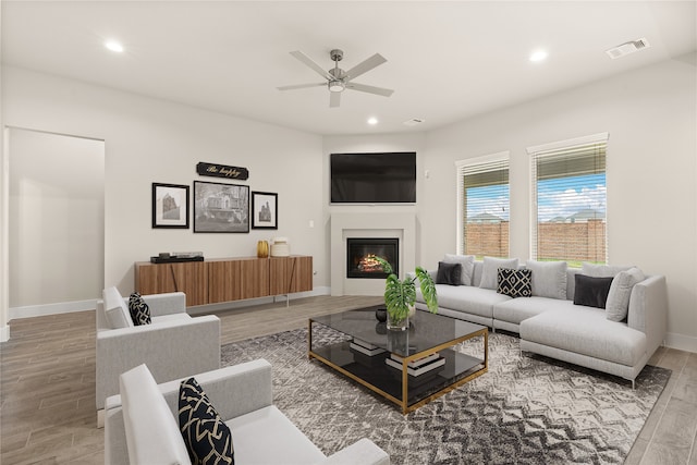 living room featuring hardwood / wood-style floors and ceiling fan