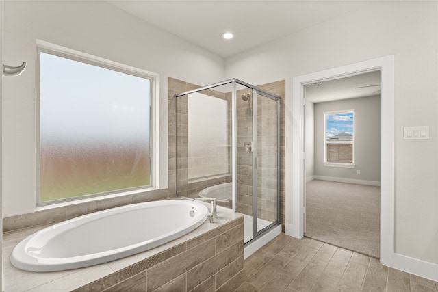 bathroom featuring hardwood / wood-style floors and independent shower and bath