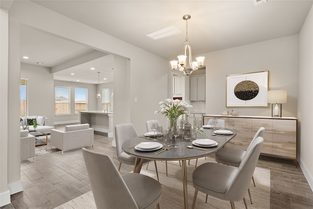 dining area featuring hardwood / wood-style floors and a chandelier