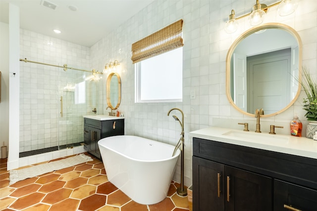 bathroom with backsplash, independent shower and bath, vanity, tile patterned floors, and tile walls