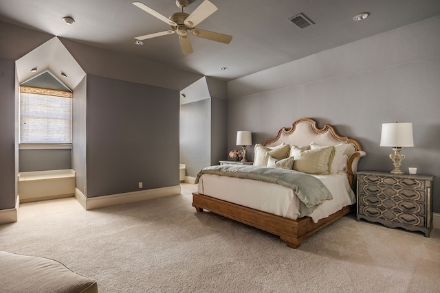 carpeted bedroom with ceiling fan, connected bathroom, and vaulted ceiling