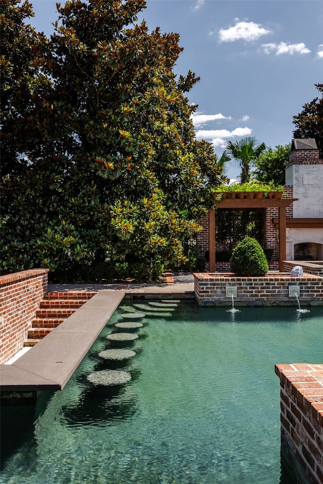 view of swimming pool with a water view