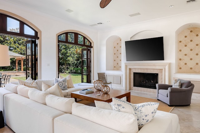 tiled living room with a fireplace and crown molding