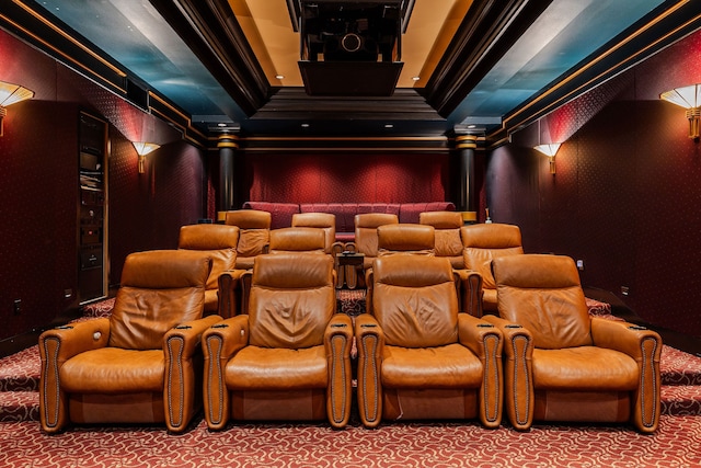 home theater featuring carpet flooring, ornamental molding, and a tray ceiling