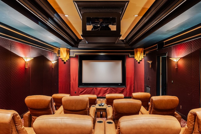 home theater room featuring crown molding and a tray ceiling