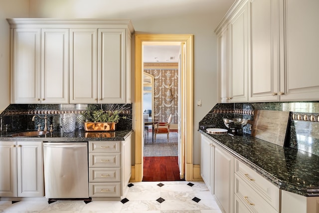 kitchen with dishwasher, dark stone counters, light wood-type flooring, and tasteful backsplash