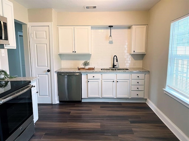 kitchen featuring sink, white cabinets, decorative backsplash, stainless steel appliances, and dark hardwood / wood-style flooring