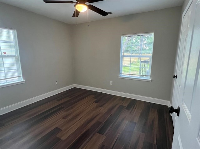 empty room featuring ceiling fan and dark wood-type flooring