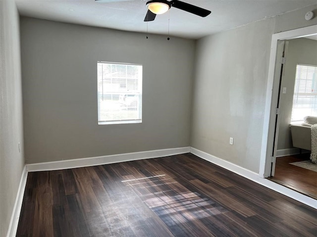 unfurnished room with ceiling fan and dark hardwood / wood-style floors