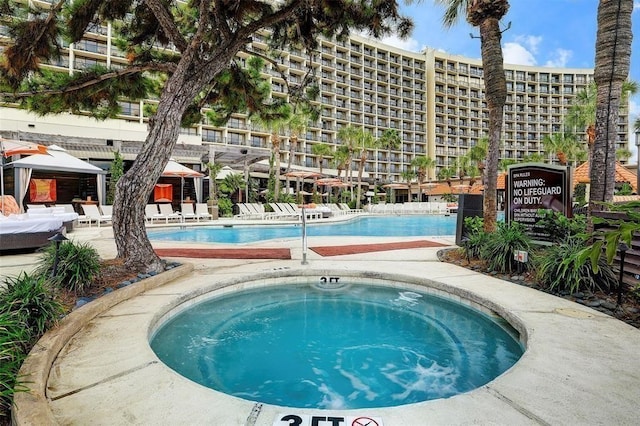 view of pool with a hot tub and a gazebo