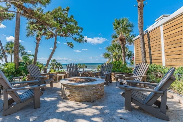 view of patio / terrace with a water view and an outdoor fire pit