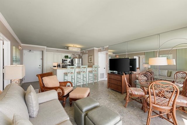 living room with ornamental molding and ceiling fan