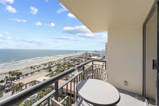 balcony featuring a beach view and a water view