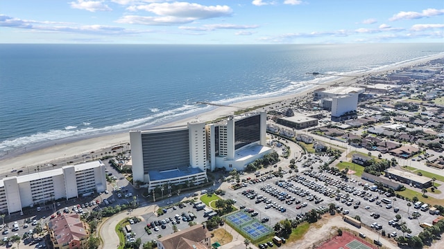 birds eye view of property featuring a beach view and a water view