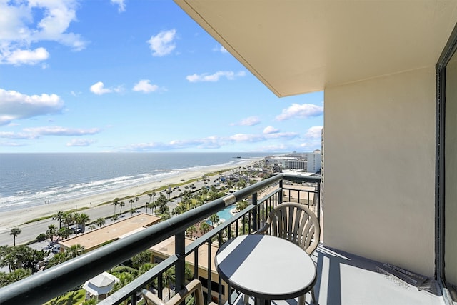 balcony with a beach view and a water view