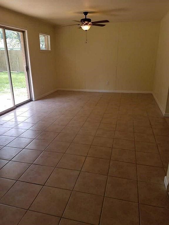 spare room featuring ceiling fan and tile patterned floors