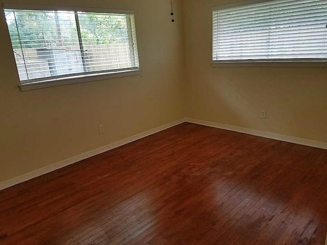 spare room with hardwood / wood-style floors