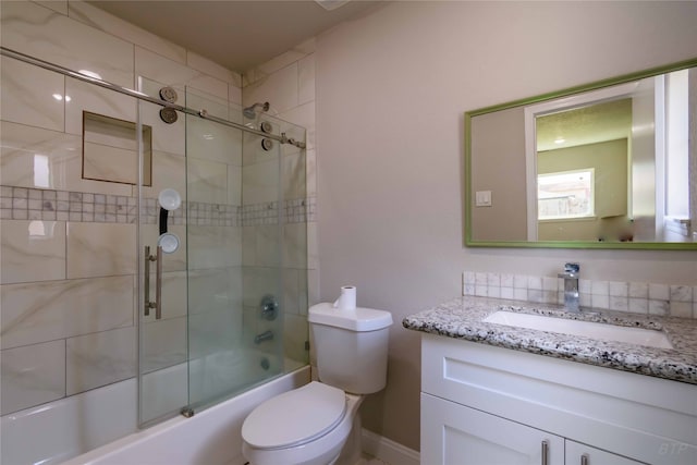 full bathroom featuring shower / bath combination with glass door, vanity, and toilet