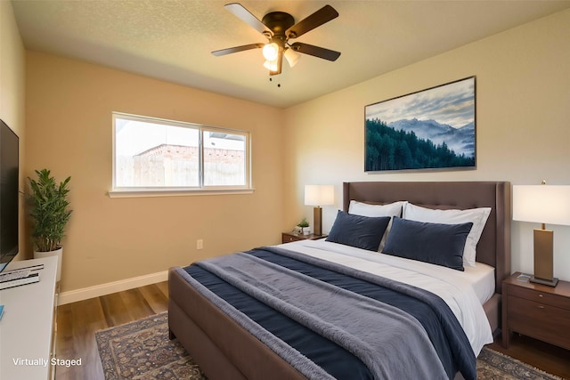 bedroom with ceiling fan and dark wood-type flooring