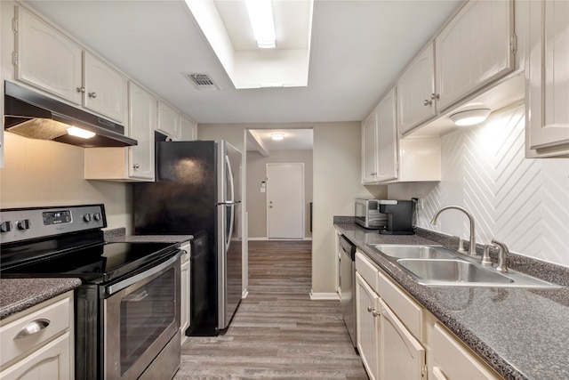 kitchen with appliances with stainless steel finishes, sink, light hardwood / wood-style flooring, and white cabinets