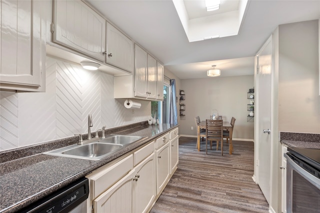 kitchen featuring white cabinetry, appliances with stainless steel finishes, hardwood / wood-style flooring, and sink