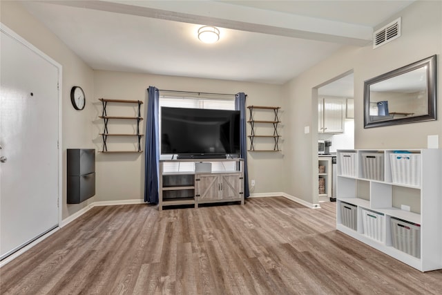 unfurnished living room featuring hardwood / wood-style flooring