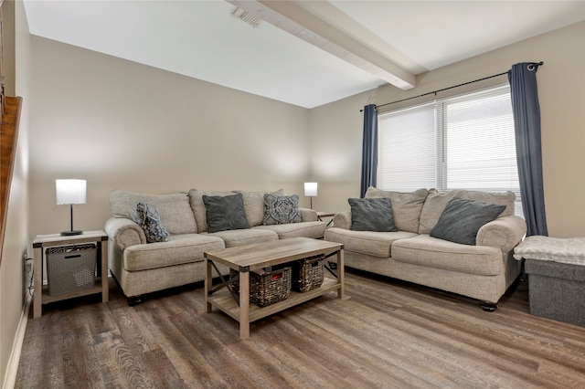 living room with beam ceiling and dark wood-type flooring