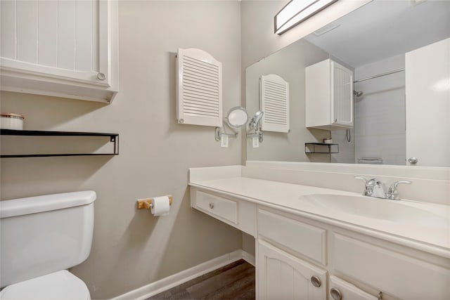 bathroom with vanity, a shower, hardwood / wood-style floors, and toilet