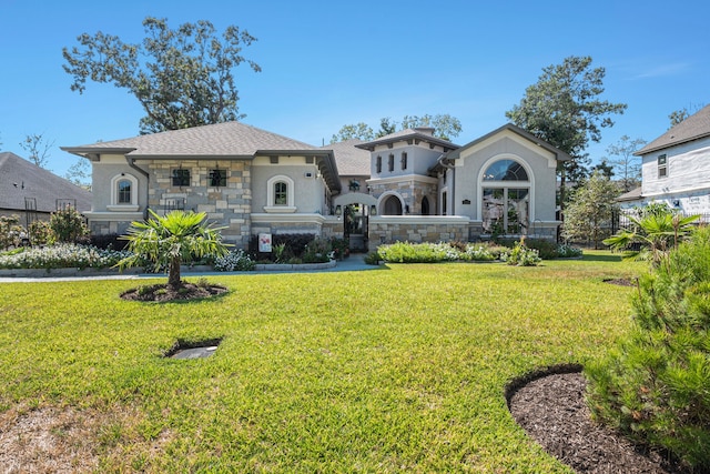 mediterranean / spanish house featuring a front yard