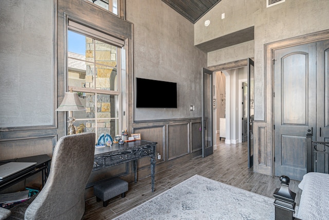 office with ornamental molding, hardwood / wood-style floors, and high vaulted ceiling