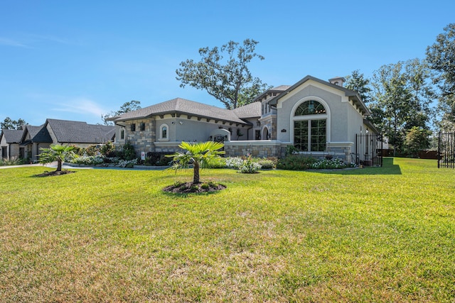 rear view of property featuring a yard