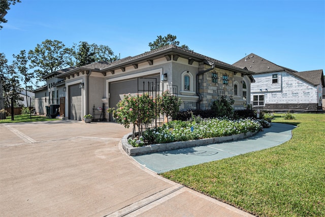 view of front facade with a garage and a front lawn