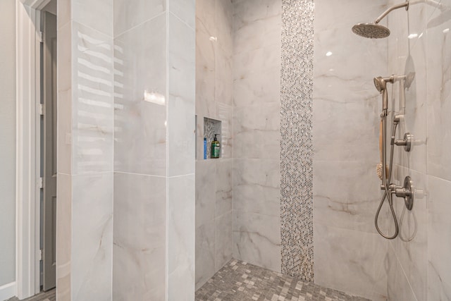 bathroom with tiled shower