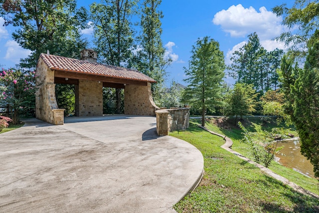 view of side of home featuring a gazebo, a lawn, and a patio area