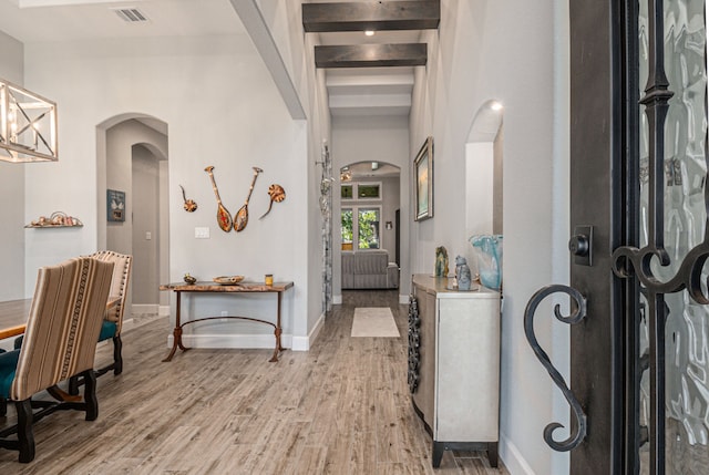 foyer with beam ceiling and hardwood / wood-style flooring