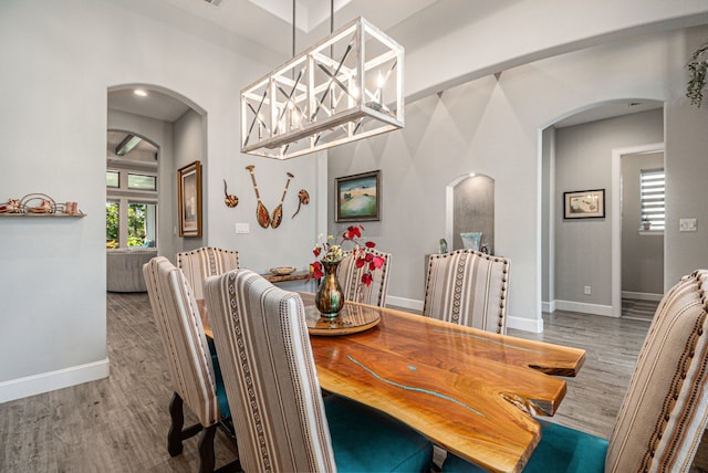 dining room featuring an inviting chandelier and hardwood / wood-style flooring