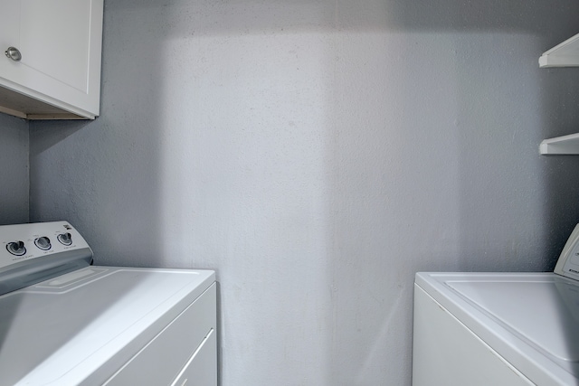 laundry area with cabinets and independent washer and dryer