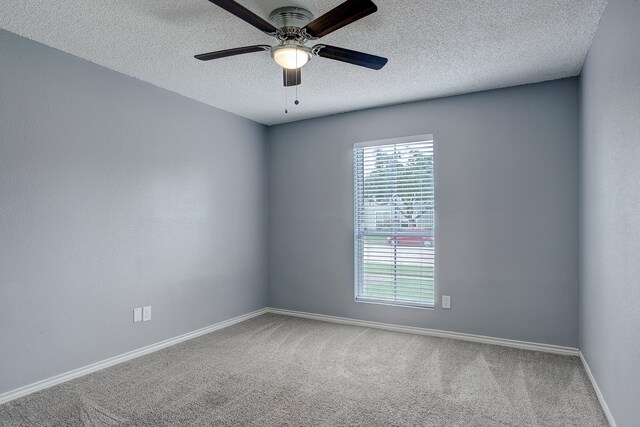 carpeted empty room with a textured ceiling and ceiling fan