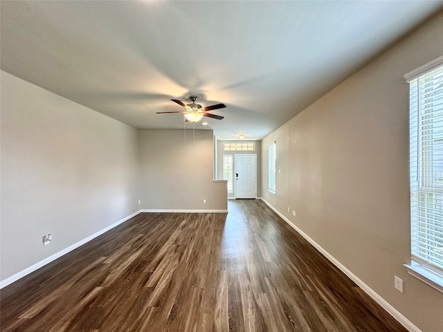 spare room featuring dark hardwood / wood-style flooring and ceiling fan