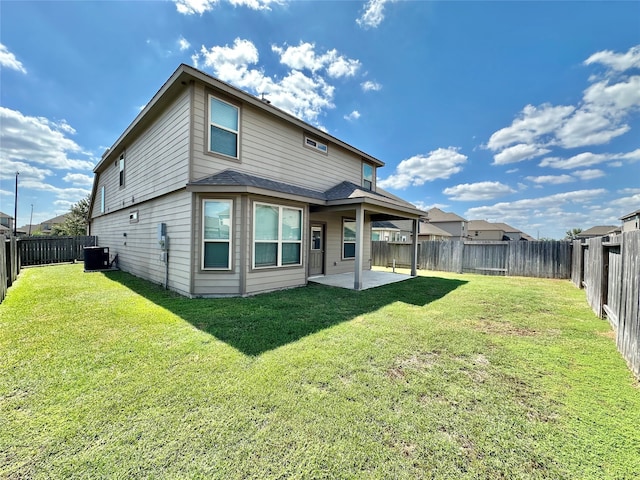 rear view of property with a patio, cooling unit, and a yard