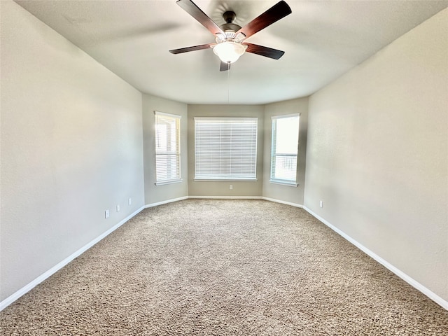 unfurnished room with carpet flooring, ceiling fan, and a healthy amount of sunlight