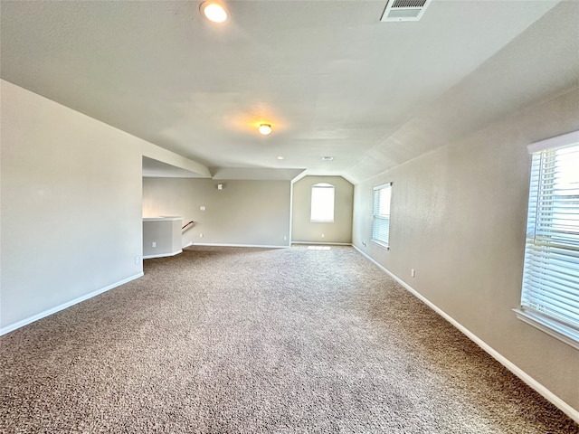 empty room with lofted ceiling and carpet floors