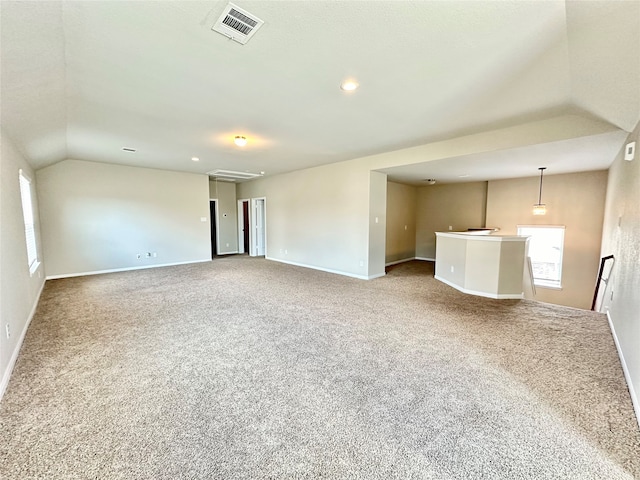 unfurnished living room with lofted ceiling and carpet