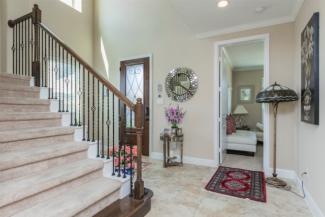 foyer entrance featuring crown molding