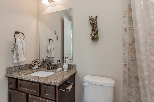 bathroom with vanity, toilet, and a shower with shower curtain