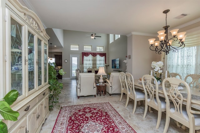 dining space with ceiling fan with notable chandelier and crown molding