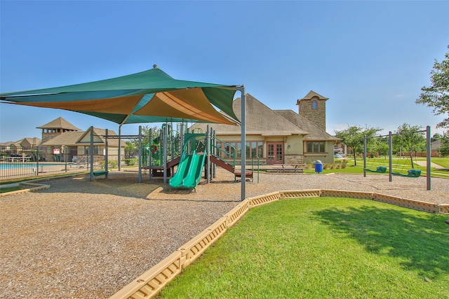 view of play area featuring a swimming pool and a yard