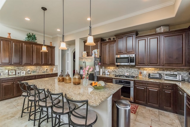 kitchen with dark brown cabinetry, a kitchen island, pendant lighting, and stainless steel appliances